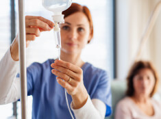 Nurse Practitioner Providing Intravenous Therapy For Patient In Mesa